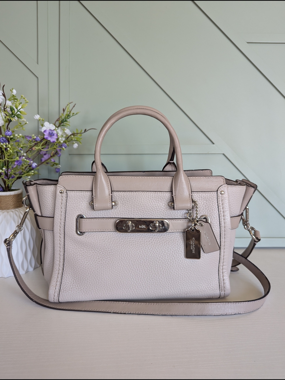 Coach Swagger. 27 Carryall, recognizable by its signature double-turnlock hardw